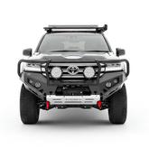 Front view of a Toyota SUV with additional lighting, Rockarmor bullbar and equipment on a white background