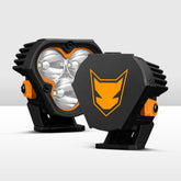 Two black and orange off-road lights on a white background