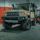 Toyota Land Cruiser with additional off-road equipment in a garage setting