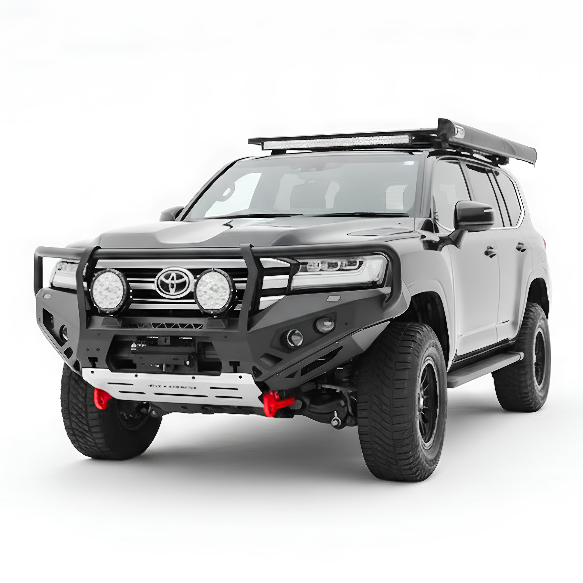 A black Toyota Land Cruiser SUV with a heavy-duty black front bumper guard, roof rack, and off-road tires, shown on a white studio background.
