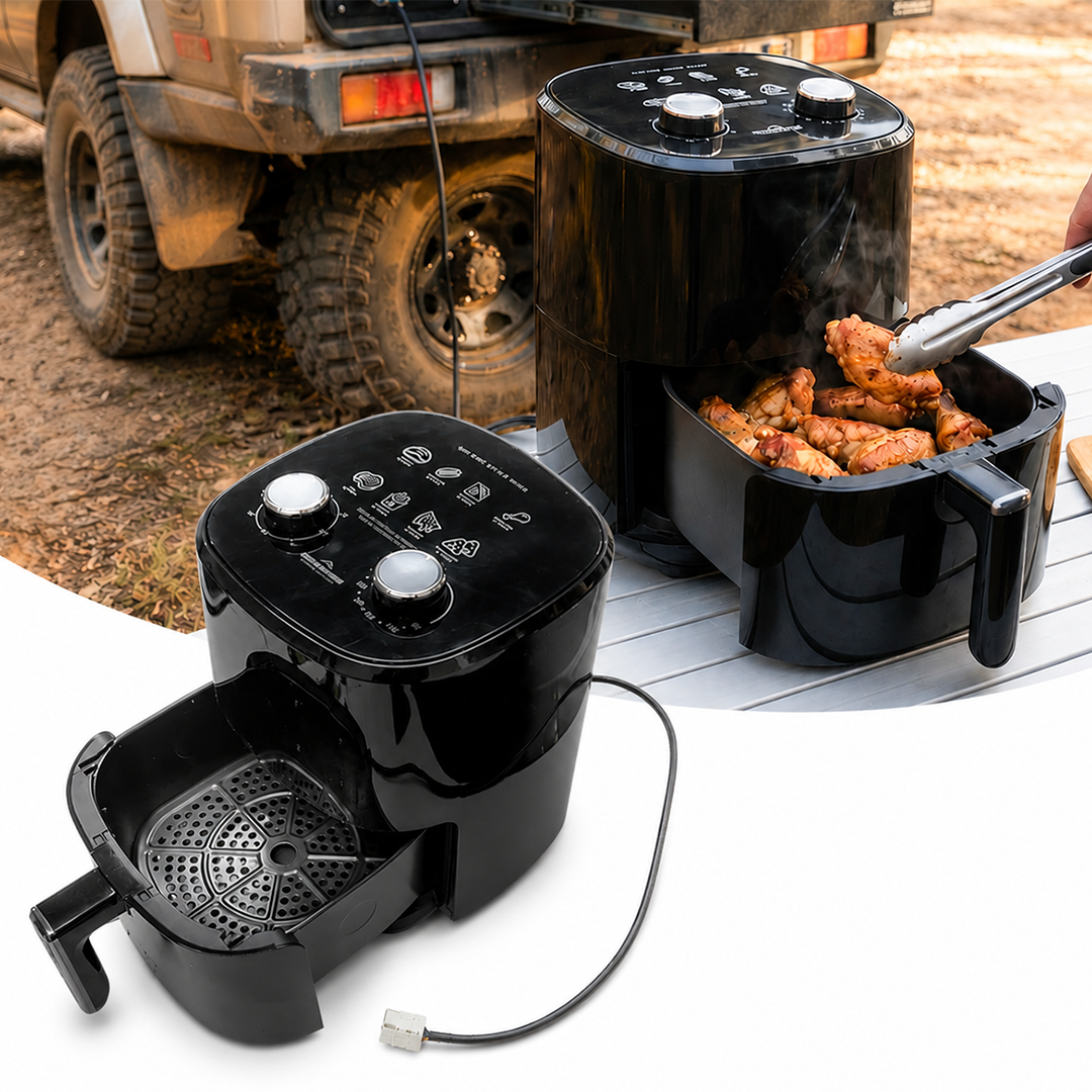 Black 12V air fryer with food being cooked outdoors, with a vehicle in the background.