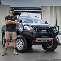Man standing in front of a large Isuzu bakkie with a modern design bull bar.