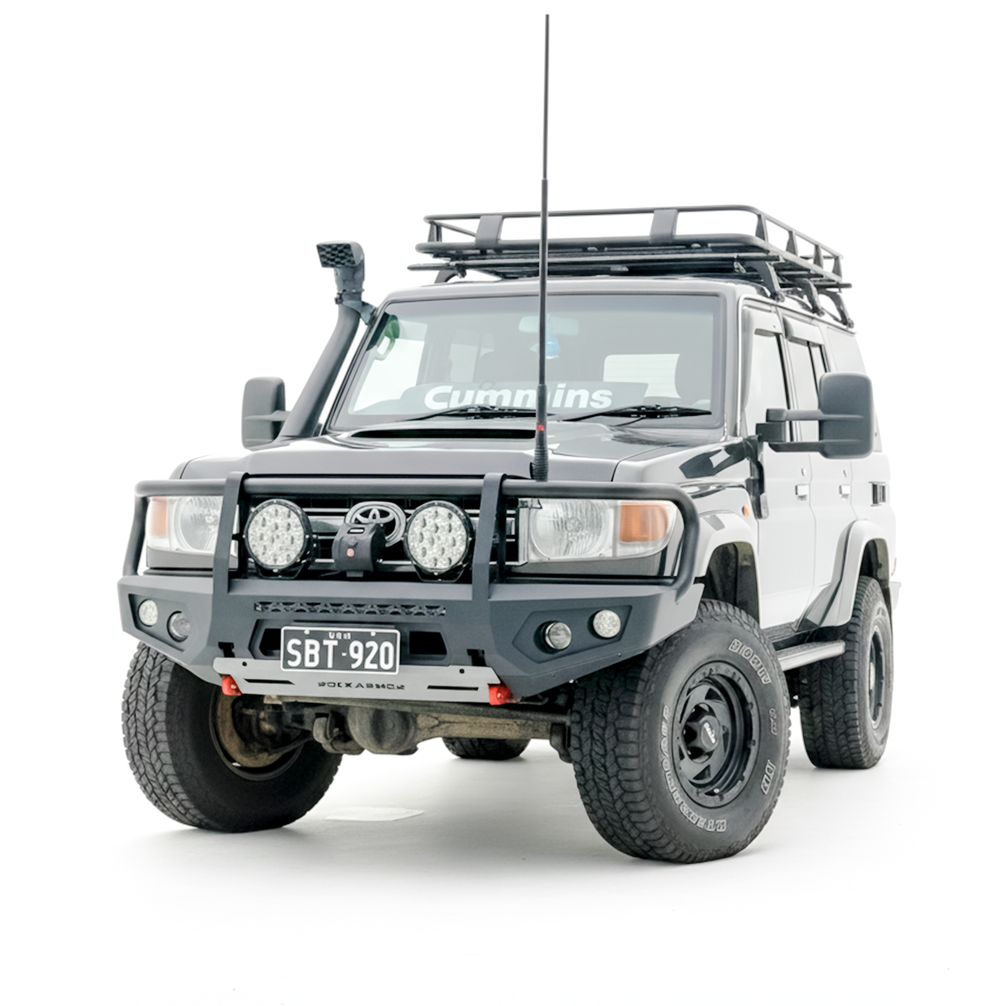 Gray off-road vehicle with roof rack and bullbar on a white background