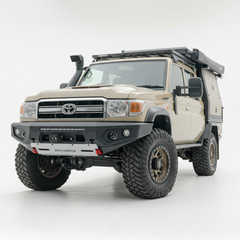 Beige Toyota truck with off-road modifications on a white background