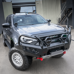 Gray Isuzu SUV with additional off-road features and bull bar in a garage setting