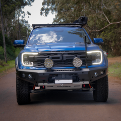 Blue Ford Ranger bakkie on a dirt road with trees in the background showcasing rugged Rockarmor front bumper.