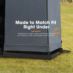 Outdoor shower enclosure with text 'Made to Match Fit Right Under' on a grassy background