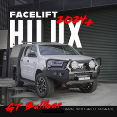 A white pickup truck bakkie with a black bullbar and rear utility cover parked in front of a dark garage door. Large overlaid text reads 'FACEFLIFT HILUX 2024+' and 'GT Bullbar 04/24+ WITH GRILLE UPGRADE'.