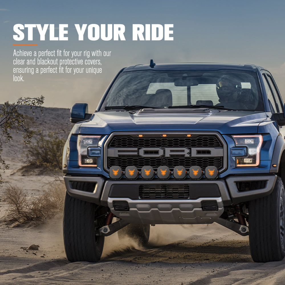 Blue Ford Ranger bakkie truck in a desert setting with protective light covers.