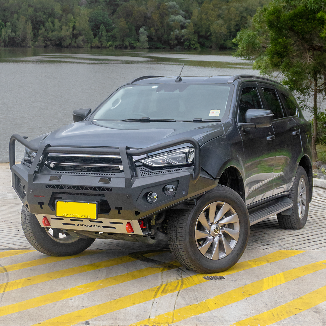 Gray Isuzu MU-X SUV with a Rockarmor front bumper bull bar on a paved surface.