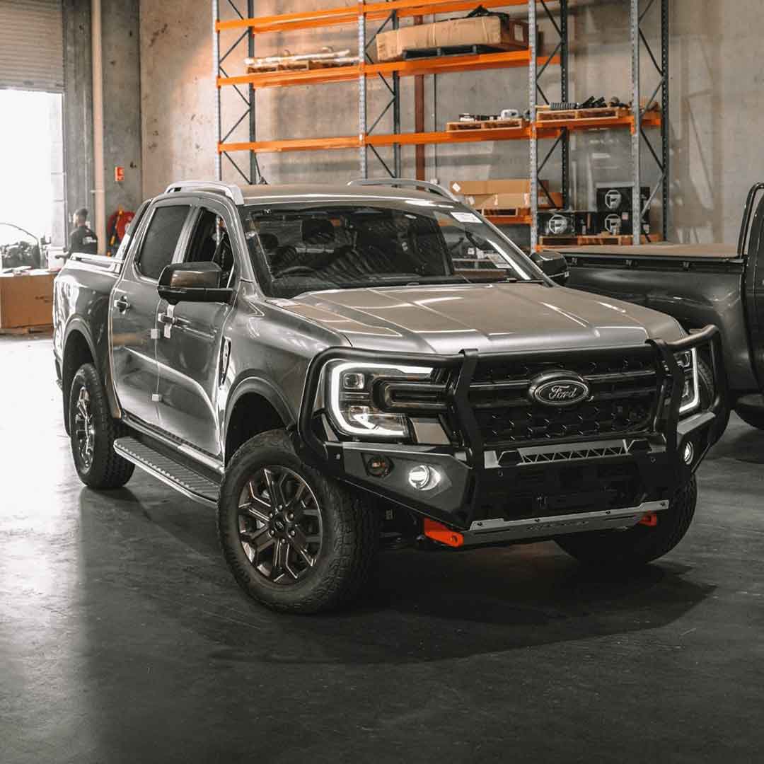 Silver Ford pickup truck bakkie in a warehouse setting with a Rockarmor bull bar installed.