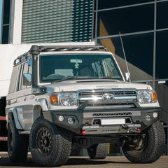 Toyota Land Cruiser parked in front of a modern building.