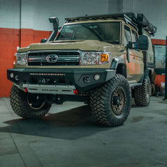 Toyota Land Cruiser with additional off-road equipment in a garage setting