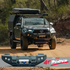 Toyota Hilux driving on a dusty hill road with a Rockarmor GT bullbar bumper in the foreground.