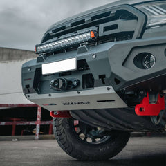 Close-up of a vehicle's Rockarmor front bumper with additional lights and a red accent on a cloudy day.