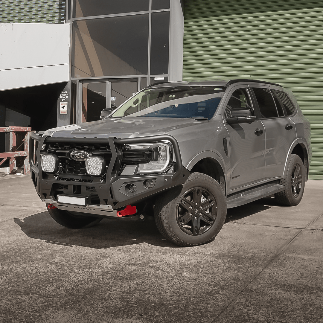 Grey Ford Everest SUV with a black grille and Rockarmor bumper bull bar