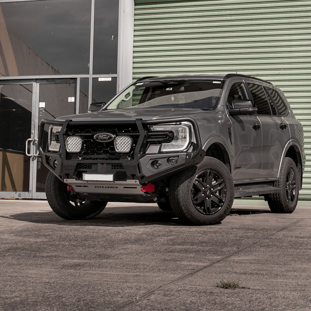 Grey Ford Everest SUV with a black grille and Rockarmor bumper bull bar