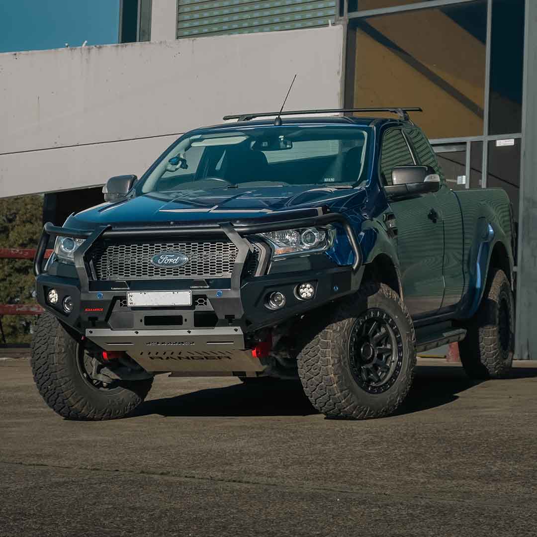 Ford bakkie truck with bull bar parked on a concrete surface with a building in the background
