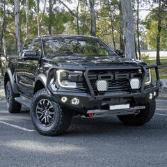 Gray Ford Ranger Raptor bakkie pickup truck with Rockarmor front bumper bull bar parked outside on a tar surface