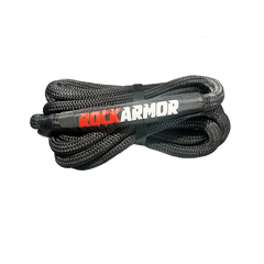 A coiled black braided kinetic recovery rope secured with a black strap, featuring the brand name 'ROCKARMOR' printed in red and white on the center, set against a plain white background.