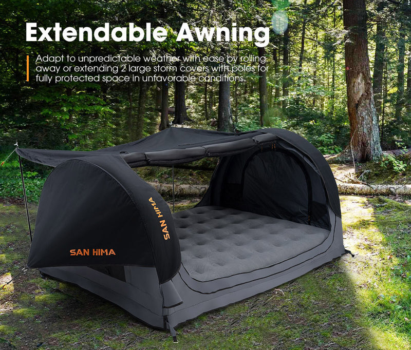 Camping setup with extendable awning and air mattress in a forest setting