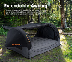 Camping setup with extendable awning and air mattress in a forest setting