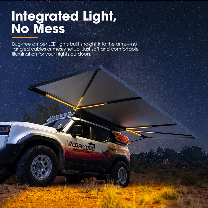 Off-road vehicle with an extended roof tent awning illuminated by amber LED lights against a night sky.