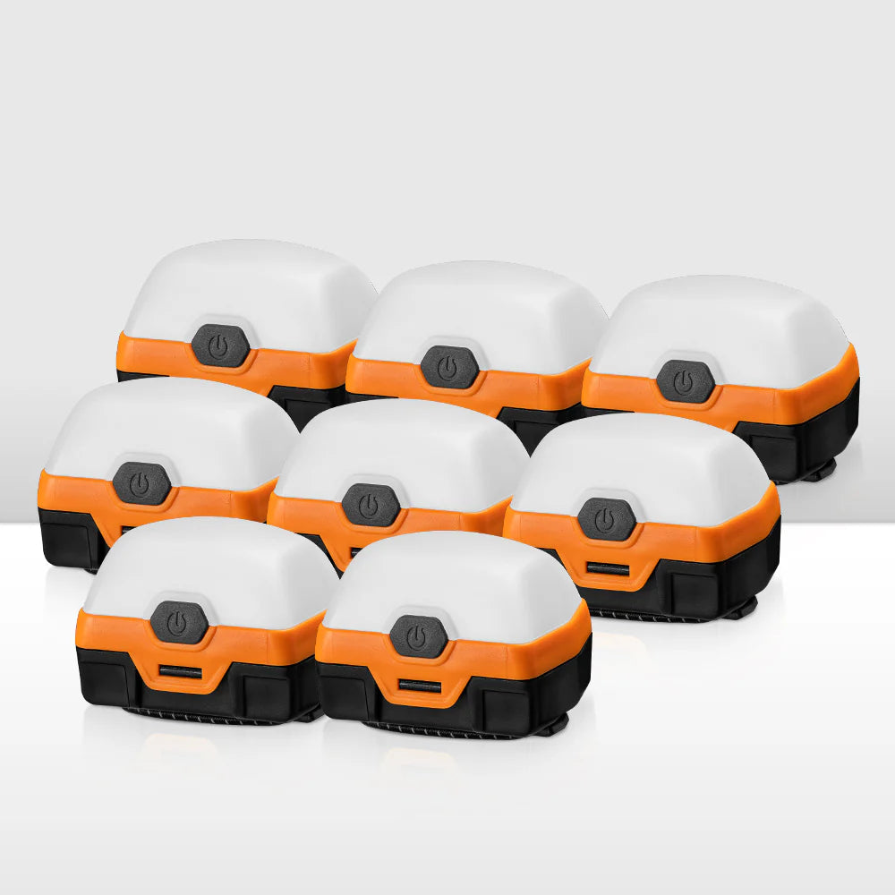 Set of orange and black LED camping lights on a white background