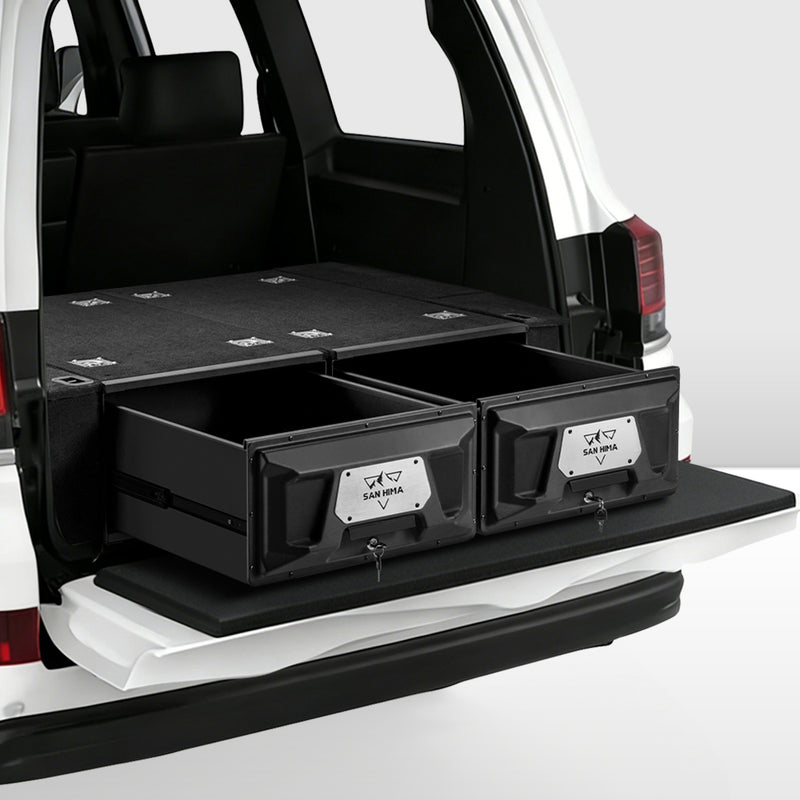 Black storage drawers in the back of a vehicle with visible branding.