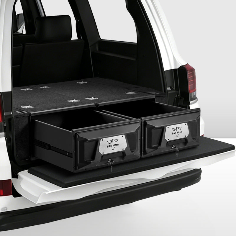 Black storage drawers in the back of a vehicle with visible branding.