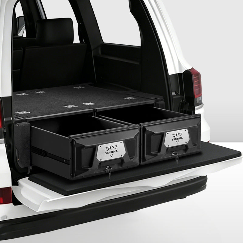 Black storage drawers in the back of a white Toyota Land Cruiser SUV on a white background