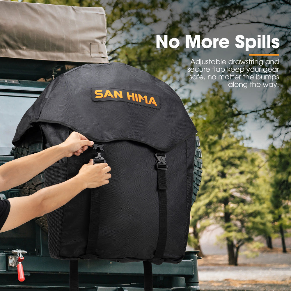 Person securing a black wheel bag on a vehicle with 'SAN HIMA' branding, outdoors.