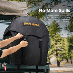 Person securing a black wheel bag on a vehicle with 'SAN HIMA' branding, outdoors.