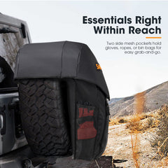 Black tire bag cover with side mesh pockets on a vehicle, set against a desert landscape.