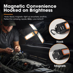 Portable work light with magnetic and hook features, used for automotive repairs.