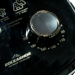 Close-up of a black RockArmor Outback Traveller air fryer control panel dial with temperature markings and white printed text, including 'Chicken Nuggets' and 'Pizza'.